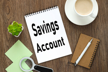 saving account. notepad on a wooden background with text