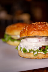 close-up burger with cutlet, sauce and herbs