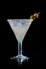Cocktail on bar counter in a restaurant, pub. Fresh drink. Alcoholic cooler beverage on an isolated black background