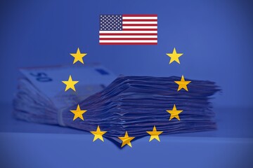 Pile of fifty euros on the table with the European Flag and the American Flag, concept of financial relation between Europe and United States of America