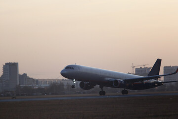 Plakat Passenger plane takes off from the airport runway. Side-view of aircraft