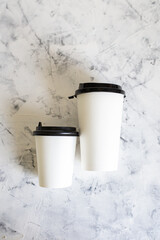 white coffee cups on textured background. eco-friendly tableware