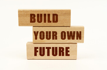 On a white surface are wooden blocks with the inscription - build your own future