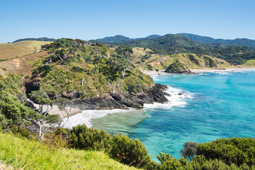 Looking into a bay of the Bay of Island in New Zealand with turquoise clear water on a sunny day...