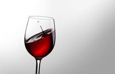 Glass with red wine on a gray background