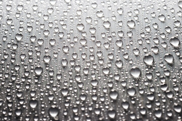 Gray flat metallic surface with drops of water. Abstract background of metal texture