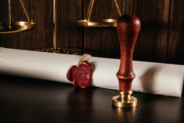 Notarial wax seal and document on courtroom with scales. Law concept