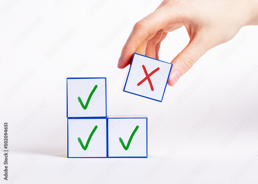 Poster hand choosing cube with cross instead of blocks with check mark. negative decision, rejection choice