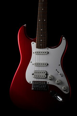 Fototapeta na wymiar Red electric guitar on a black background. Fender