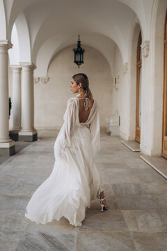 The bride in a flowing wedding dress. Castle wedding.