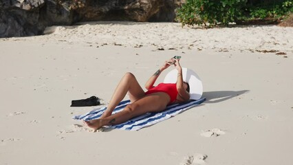 Woman Lying On Beach Taking Selfie With Smartphone