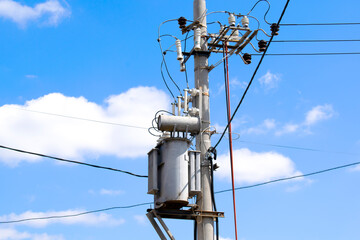 High Electric voltage wires and pole power lines,electric towers,power transformer against vibrant...