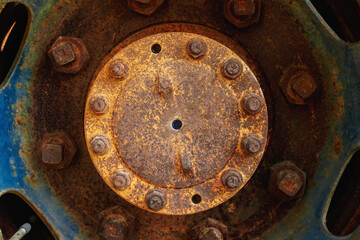 Corrosive car wheels, garage part, bolted, carving wheel disc, Metal sheet, nuts, screws, traces of rust and old paint and metal corrosion, cracks.                
