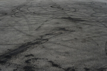 Asphalt texture with white line and tire marks. Smooth asphalt road. Tarmac dark grey grainy road background.Top view - 502097893