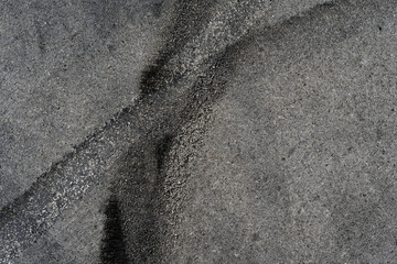 Asphalt texture with white line and tire marks. Smooth asphalt road. Tarmac dark grey grainy road background.Top view - 502098219