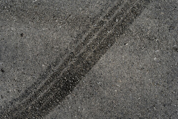 Asphalt texture with white line and tire marks. Smooth asphalt road. Tarmac dark grey grainy road background.Top view - 502098408