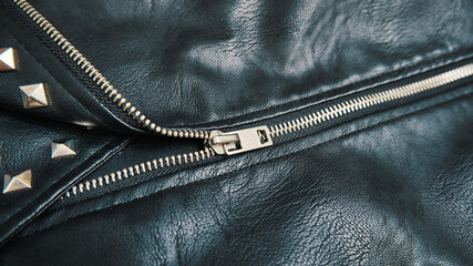 Black leather jacket with chrome metal zip close-up