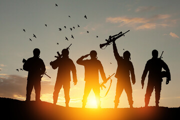 Silhouettes of soldiers against the sunrise. Concept - protection, patriotism, honor. Armed forces...