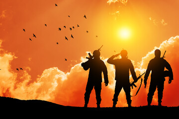 Silhouettes of soldiers against the sunrise. Concept - protection, patriotism, honor. Armed forces...