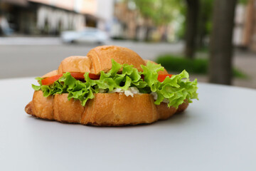 Croissant with tomatoes and herbs on the restaurant table