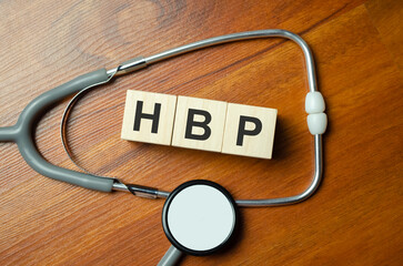 HBP High Blood Pressure text on wood block on wooden table - obrazy, fototapety, plakaty