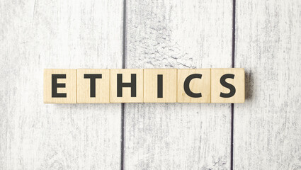The word ETHICS is written on wooden cubes
