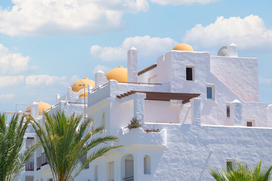 Set of Hispano-Muslim constructions with 3 large orange cupulas that stand out with an incredible blue cloudy sky