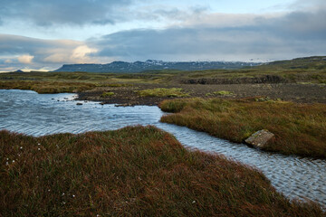 View during auto trip in West Iceland highlands, Snaefellsnes peninsula, Snaefellsjokull National Park. Spectacular volcanic tundra landscape with mountains, craters, lakes, gravel roads.