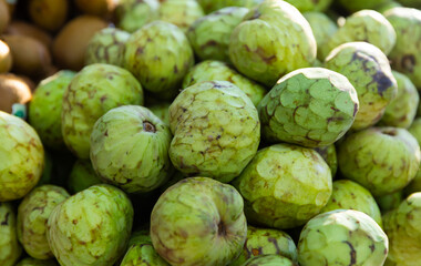 Fototapeta premium Organic chirimoya fruits or custard apples ready for sale in greengrocery