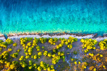 Coast with rocks as a background from top view. Blue water background from top view. Summer seascape from air.