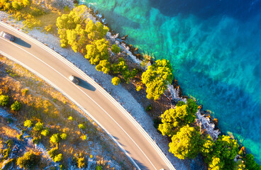 View of the road along the coast from the drone. Travel by car in summer time. The sea coast and...