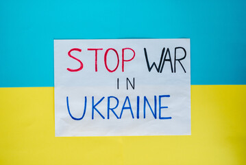 Stop war in Ukraine. Banner with inscription against the background of the yellow and blue flag of Ukraine. Protest against war. Slogan or message about the end of war. No war, russian aggression.
