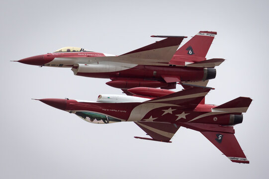 Avalon, Australia - February 24, 2015: Two Republic of Singapore Air Force (RSAF) Lockheed Martin F-16CJ Fighting Falcon fighter aircraft of the Black Knights display team performing a mirror flypast.