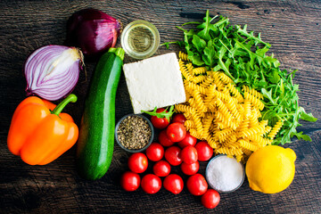 Overhead View of Roasted Veggie Pasta with Feta Ingredients: Feta cheese, vegetables, olive oil,...