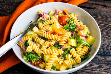 Roasted Veggie Fusilli Pasta with Feta in a Shallow Bowl: Rotini twists with roasted vegetables in a feta cheese sauce