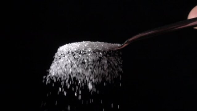 shaking sugar from a teaspoon, slow motion 10x