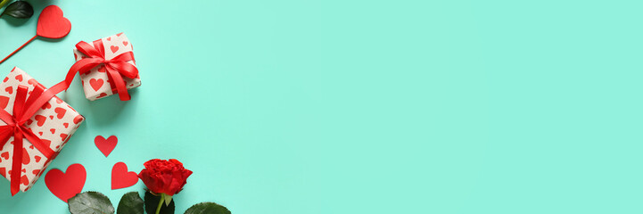 Presents for Valentine's Day, red hearts and roses on turquoise background with space for text