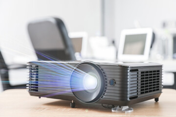 Video projector on table in conference hall