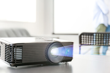 Video projector on table in conference hall