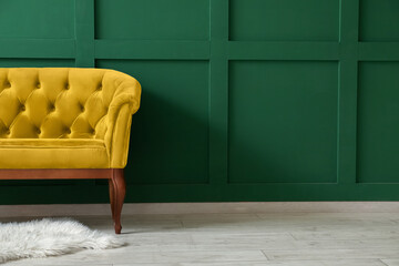 Comfortable yellow sofa near green wall - Powered by Adobe
