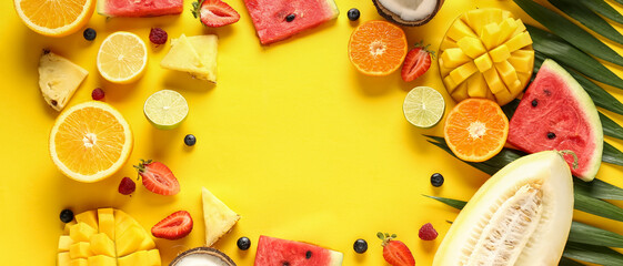 Frame made of sweet tropical fruits on yellow background