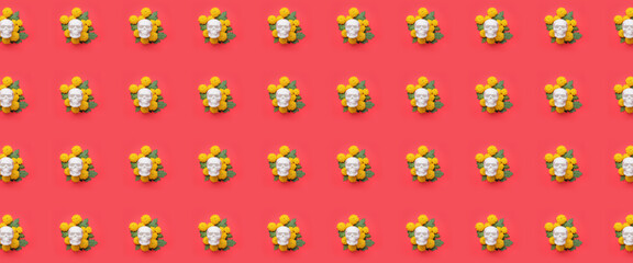 Human skulls for Mexico's Day of the Dead (El Dia de Muertos) and flowers on red background. Pattern for design
