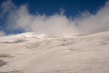 Alpine landscape. High in the Andes cordillera. View glacier Castaño Overo ice field and the clouds in Tronador hill. 