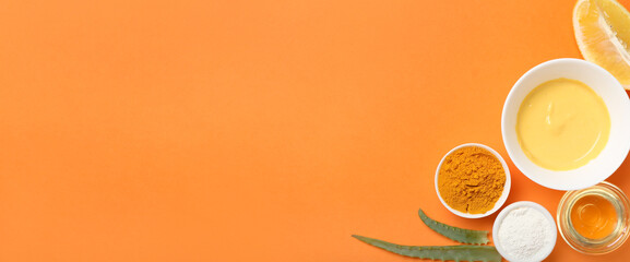 Turmeric face mask with ingredients on orange background with space for text