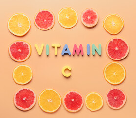 Composition with text VITAMIN C and slices of citrus fruits on color background