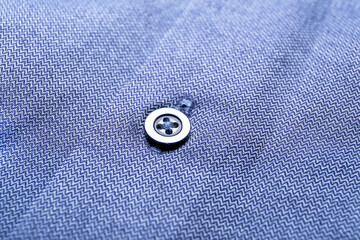Closeup view of button on stylish shirt