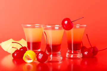 Tasty Pineapple Upside Down Cake Shots on red background, closeup