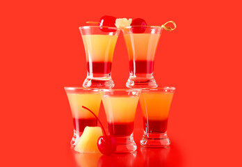 Tasty Pineapple Upside Down Cake Shots on red background