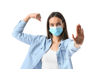 Young woman in medical mask showing stop gesture on white background. Immunity concept