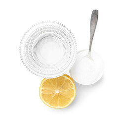 Glass of water, bowl with baking soda and lemon on white background